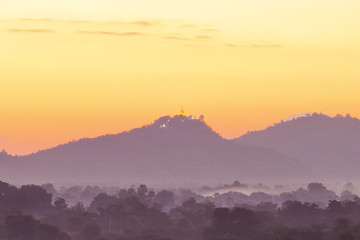 Golden Pagoda on a mountain with a spectacular fire sunrise 