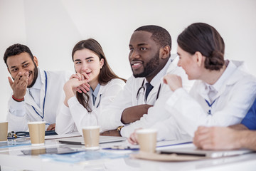 Cheerful therapeutics telling during meeting in office