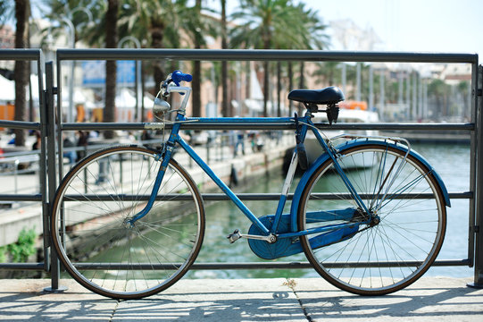 Blue bicycle near railing on a bridge