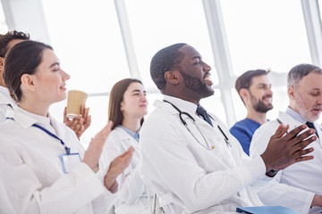 Happy therapeutics clapping hands during meeting