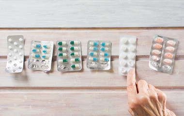 Senior woman picking her today pills