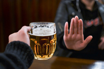 Girl refusing another glass of beer