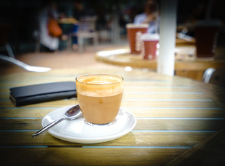 Glass of coffee with focus at the center and blurred background 
