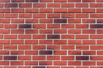 Part of a red brick wall. Wall made with decorative bricks.