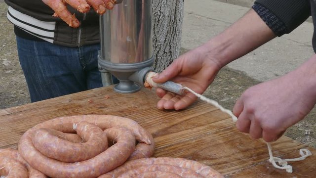 Butcher making sausage at home, outdoor, winter time Europe Balkan countries