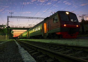 Fototapeta na wymiar The train at sunset costs at the station