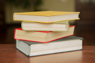 a stack of colorful books in a library