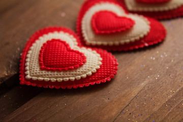 Bright red hearts on a wooden background