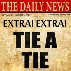 tying a tie, article text in newspaper