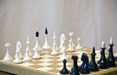 Chess game: first move the white pawn on wooden board 