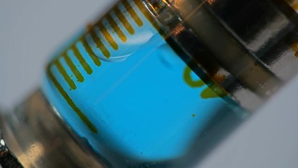 people gaining a syringe with a liquid solution on a white background