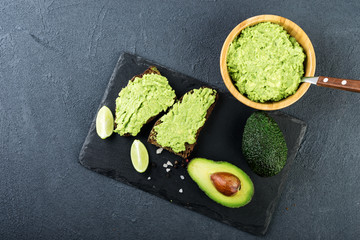  Guacamole pasta and avocado on dark background. Vegetarian  food
