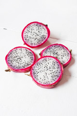 Juicy pink pitaya on wooden table
