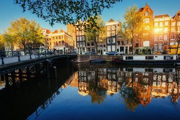 Fototapeta na wymiar Beautiful sunset in Amsterdam. Highlighting sun buildings and bo