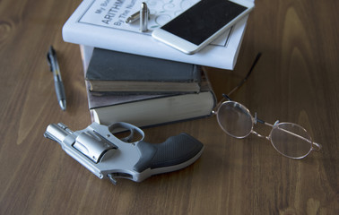 gun, school supplies, textbook has fake title