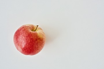 One gala apple on the white table