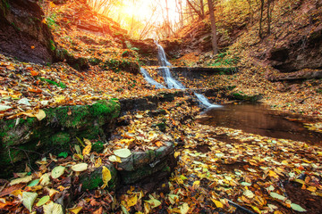 Waterfall in autumn sunlight