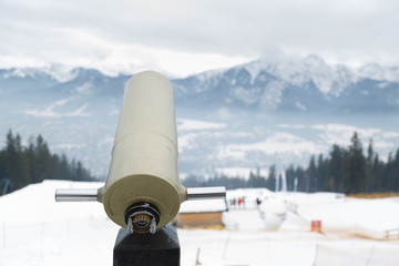 Panoramic telescope with mountain views in winter