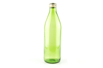 Glass empty green bottle isolated on a white background