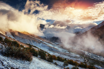 Mountain landscape of snow-capped mountains in the mist.