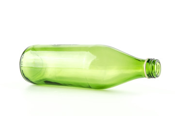 Glass green bottle lying sideways isolated on white background
