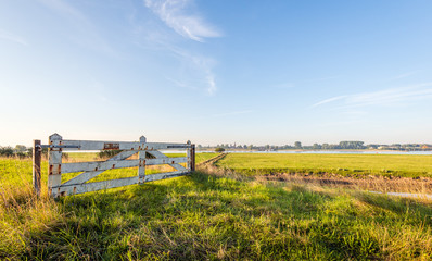Weathered wooden gate with rusty sign board forbidden entry