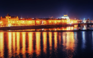 Fototapeta na wymiar Reflection of Prague caste and the Charles bridge at dusk.