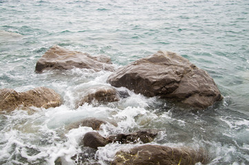 rock wave spatter, beach rock with sea wave and clear water