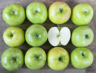 Large group of healthy, green apples on wooden table