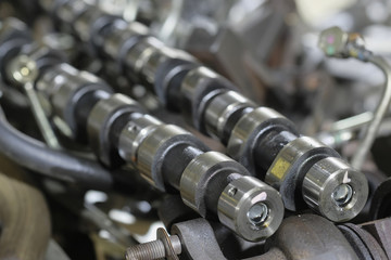 Camshaft  lies among details of the engine disassembled for repair