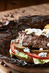 Tasty burger with fries and sauce