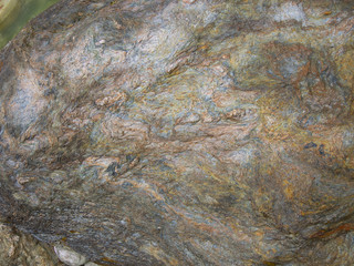 Metamorphic rocks with colorful mineral streaks.   Texture - bac