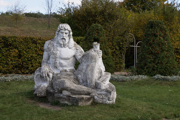 Fototapeta na wymiar Neptune statue in the garden of the castle in Zolochiv Ukraine.