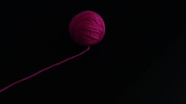 Three skeins of knitting yarn appear on black background