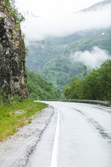 Foggy landscape with road in norwegian mountains