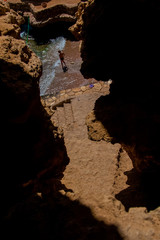 The man standing in the sea in the bay, the view from the top