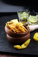 A plate of delicious tortilla nachos with melted cheese sauce, j