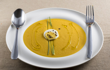 cream of pumpkin soup with boiled egg and chives pepper