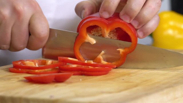 Cutting Pepper On Board With Chef Hands