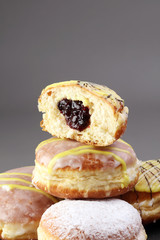 German donuts - berliner with jam and icing sugar in a tray on a