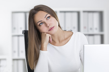 Dreamy blond girl in a white office