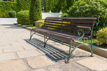 The vintage bench on pathway in the park