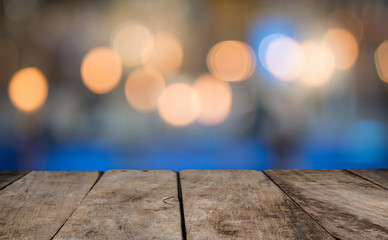 Rrustic wood table in front of glitter and bright bokeh lights