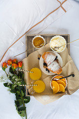 Fototapeta na wymiar Romantic breakfast with love, croissants, coffee, orange juice