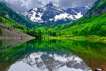 Mountain peak reflection in calm lake. Maroon Bells near Aspen, Snowmass,  Colorado State, USA.