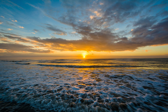 Waves in the Atlantic Ocean and sunrise, in Isle of Palms, South