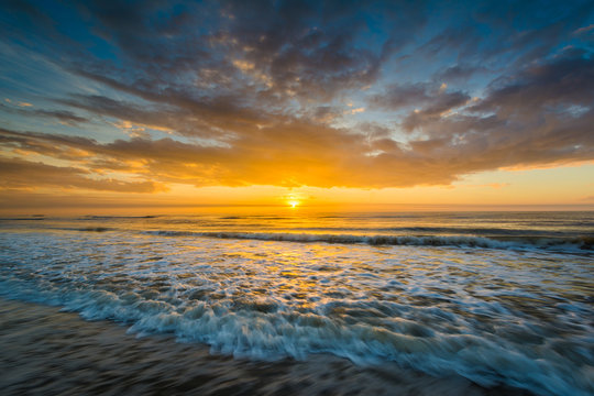 Waves in the Atlantic Ocean and sunrise, in Isle of Palms, South