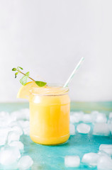 Orange juice. Orange smoothie on a turquoise background..Kiwi. Cocktails. Detox Juice. Summer drink. Healthy food concept
