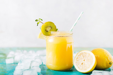 Orange juice. Orange smoothie on a turquoise background..Kiwi. Cocktails. Detox Juice. Summer drink. Healthy food concept