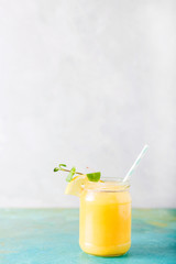 Orange juice. Orange smoothie on a turquoise background..Kiwi. Cocktails. Detox Juice. Summer drink. Healthy food concept